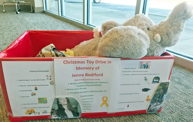 Christmas toy drive collection box filled with stuffed animals and toys